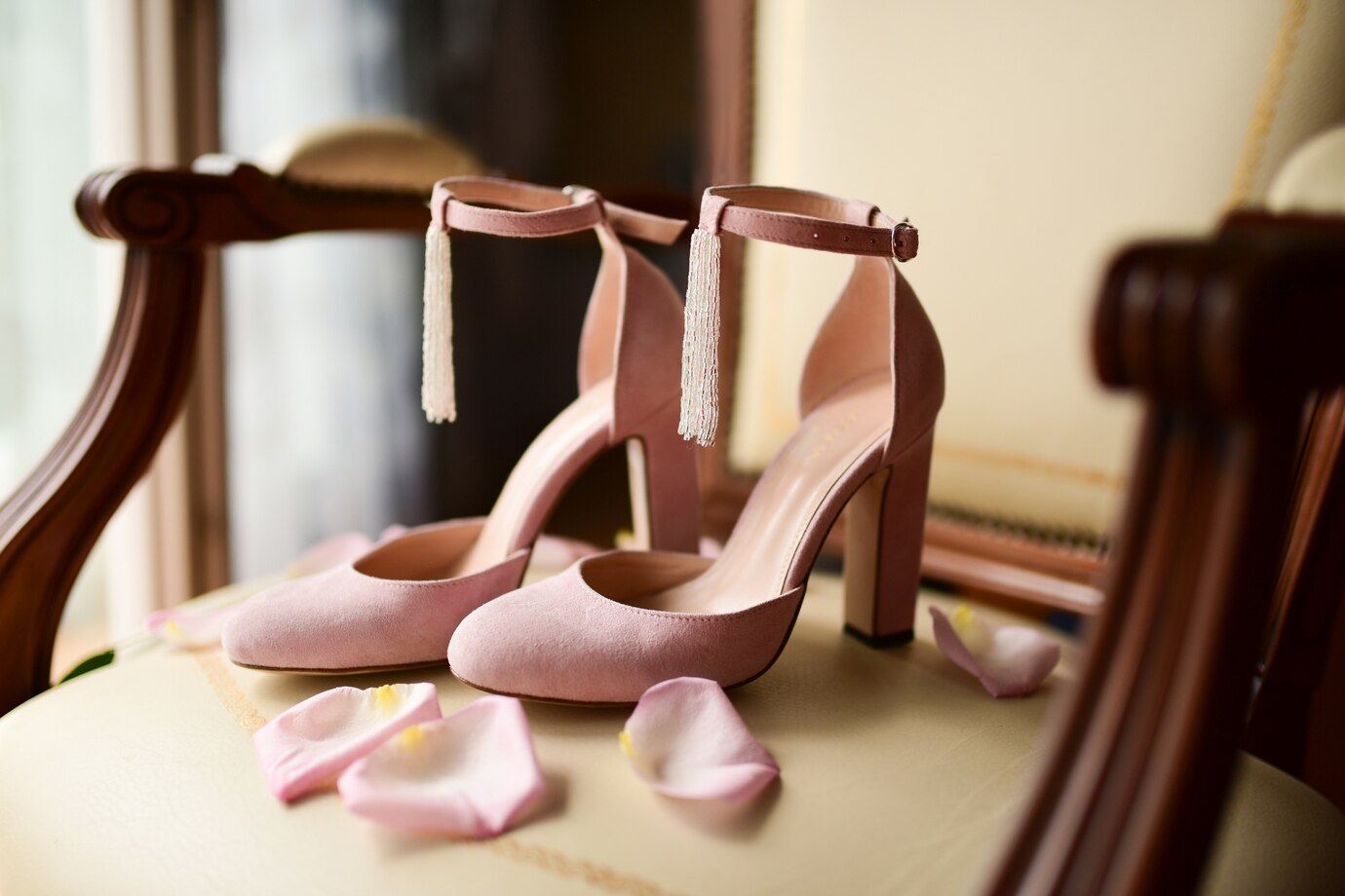 pink-bride-s-shoes-stand-chair-with-pink-rose-petals_8353-7364.jpg